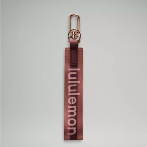 Lululemon Never Lost Keychain Wordmark- Garnet/Spiced Chai/Rose Gold